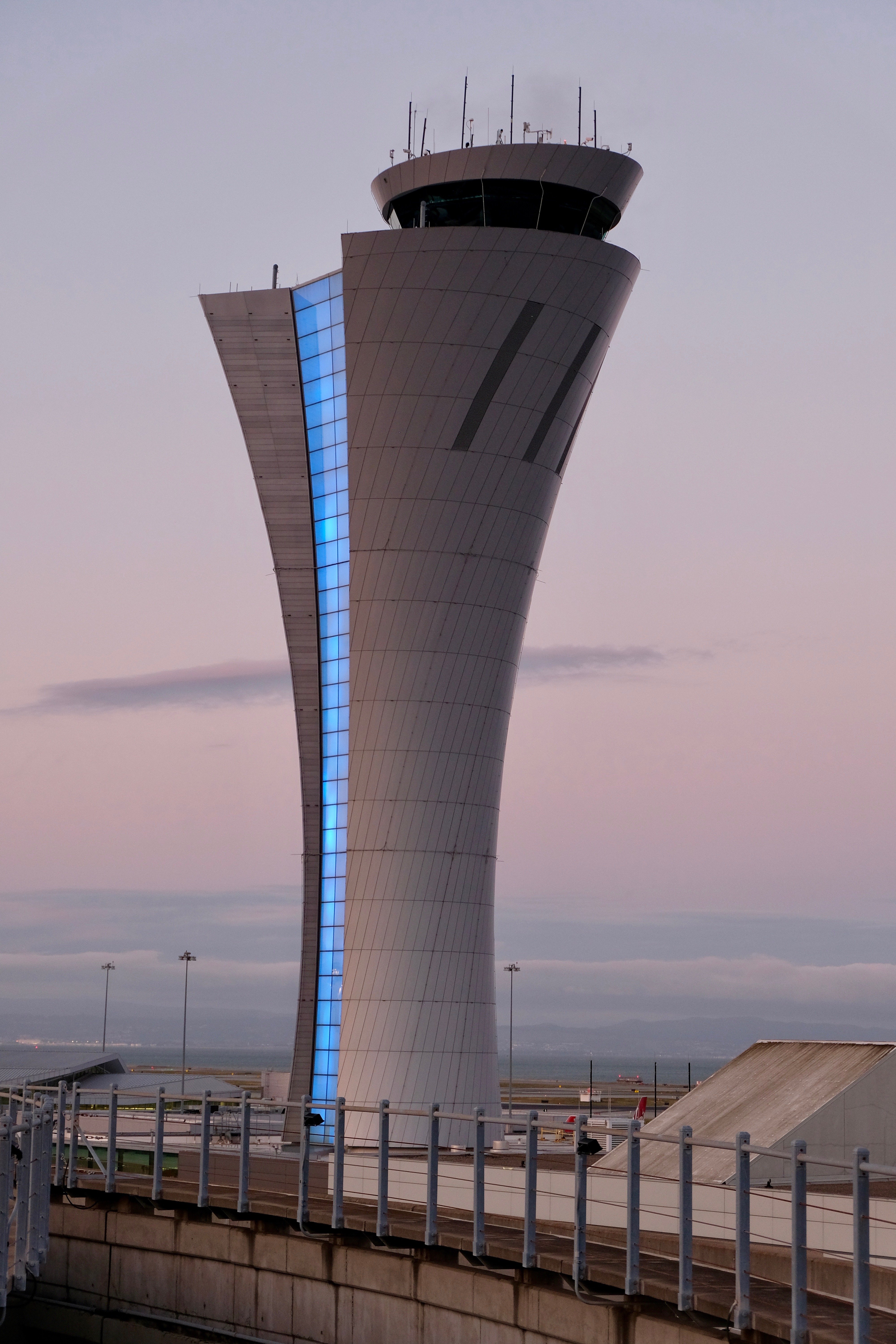 San Francisco International Airport control tower illuminated blue at dusk